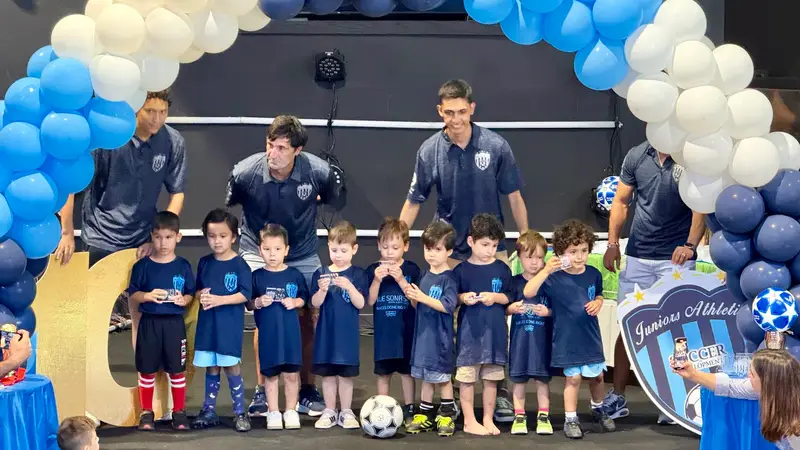 Young Juniors Athletic players with their coaches on stage