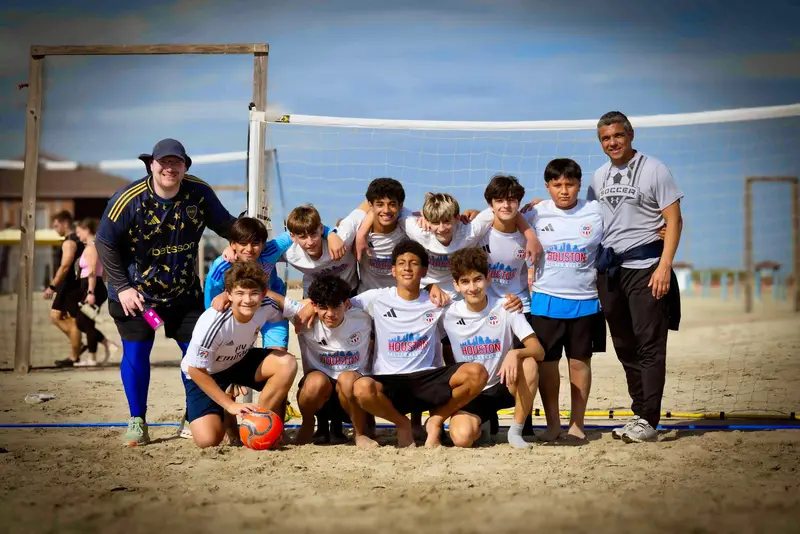 Team photo on the beach with coaches