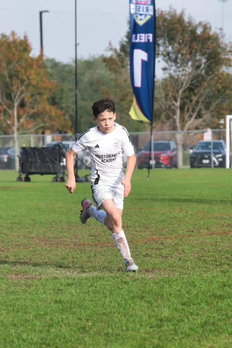 Juniors player sprinting with the ball